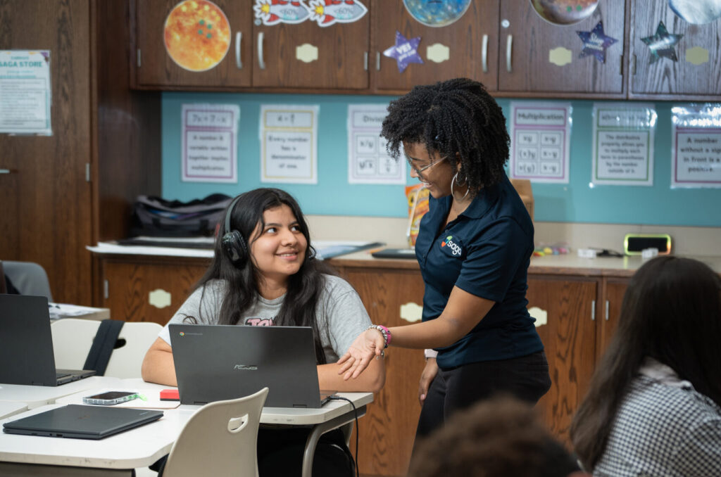 Saga Education tutor supports a student working on their laptop