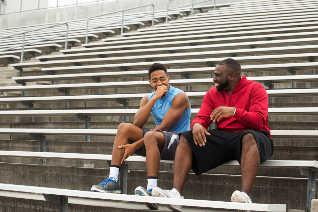 Mentor spends time with student working out on school bleachers