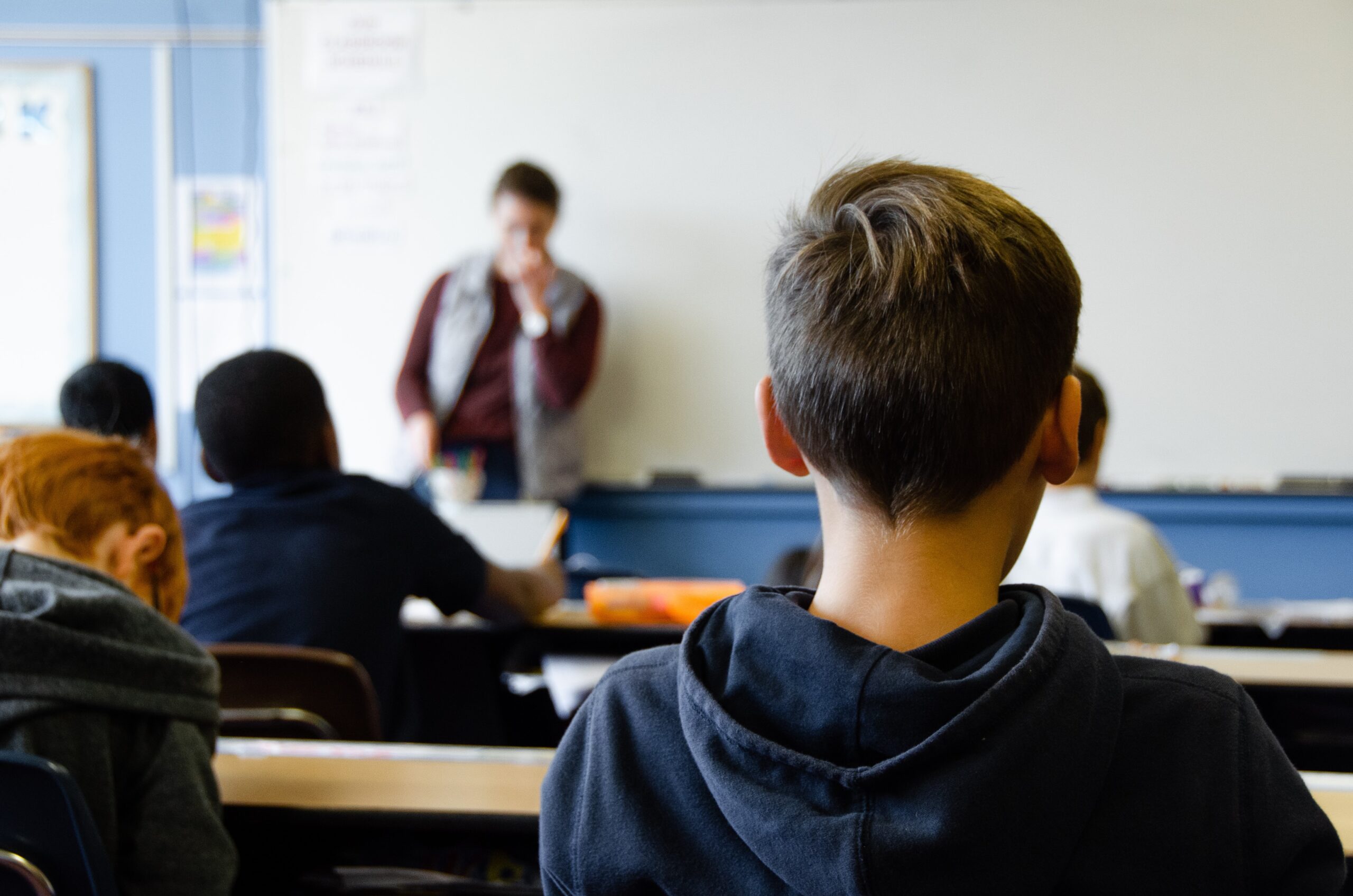 Backshot of a kid in a classroom